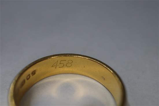 A 22ct yellow gold engraved wedding band, a similar plain band and a 9ct yellow gold signet ring with carnelian matrix.